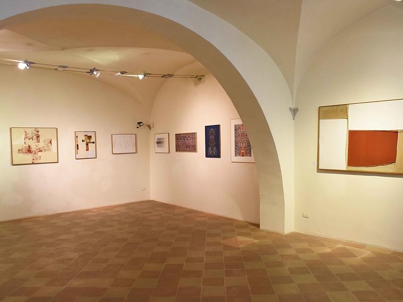 Exhibition room with abstract works on the walls in the Palazzo Vitelli Art Gallery.
