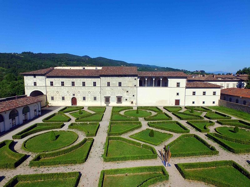 Palazzo Vitelli alla Cannoniera seen from above, with Italian-style garden and hills in the background.