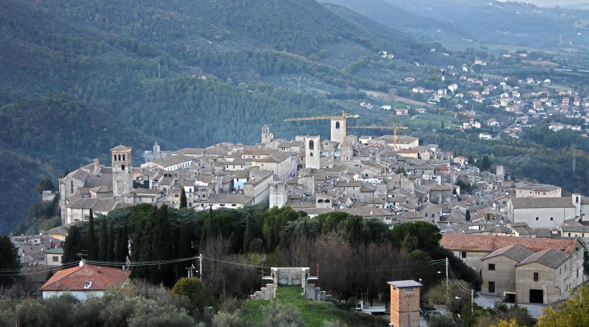 Panoramic view of Narni from the Albornoz fortress, with the surrounding valley covered in woodland.