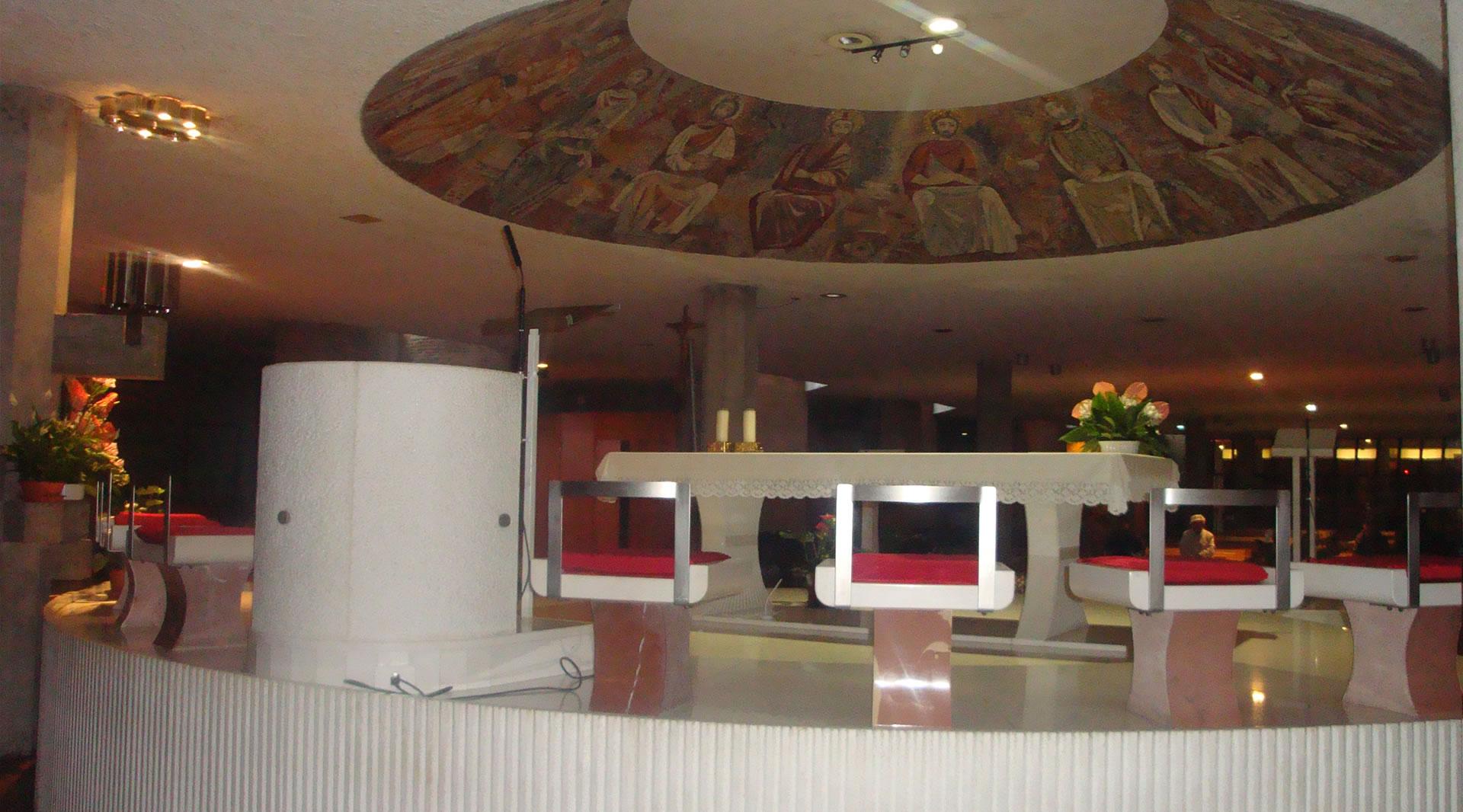 Interior of the lower church, with a raised altar topped by a circular mosaic