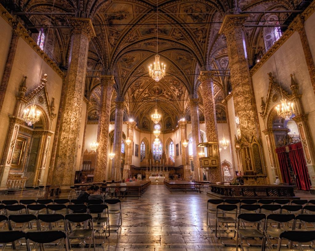 Panoramic view of San Lorenzo Cathedral’s interior, with its tall nave, grand columns, and the high altar in the background.