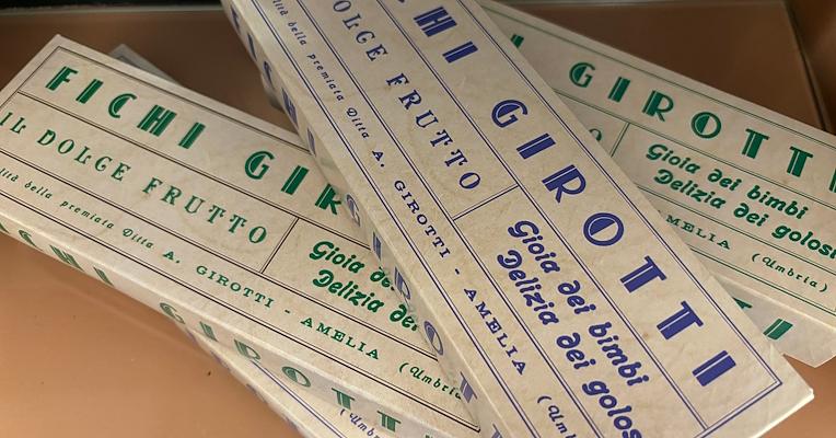 Vintage Fichi Girotti packaging from Amelia with blue and green lettering.