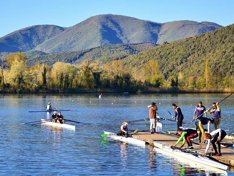 Rowers training on Lake Piediluco at the foot of the surrounding mountains.