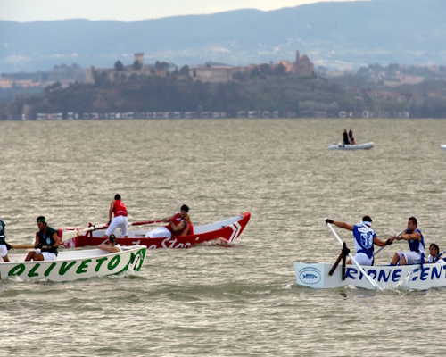 Race between the boats of the four districts of Passignano sul Trasimeno to win the Palio delle Barche
