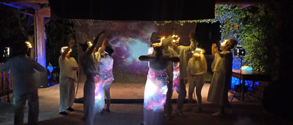 scene from the show The God of Massacre with various actors dressed in white