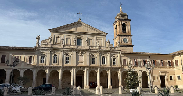  Front view of the Cathedral of Santa Maria Assunta in Terni, with a portico, statues of bishops on the upper balustrade and the bell tower on the right, with the square in front of the cathedral 
