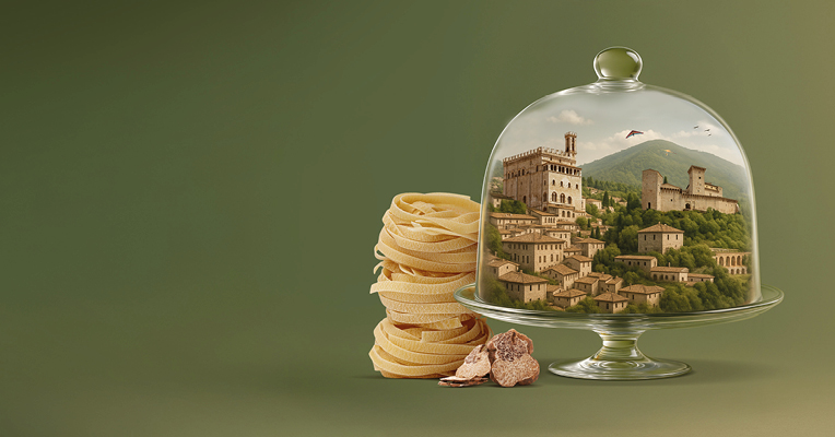 Composizione artistica che evoca il gusto ed il paesaggio del territorio di Gubbio e Gualdo Tadino: nidi di tagliatelle e tartufo e i due Comuni incapsulati in un elegante contenitore di cristallo portavivande