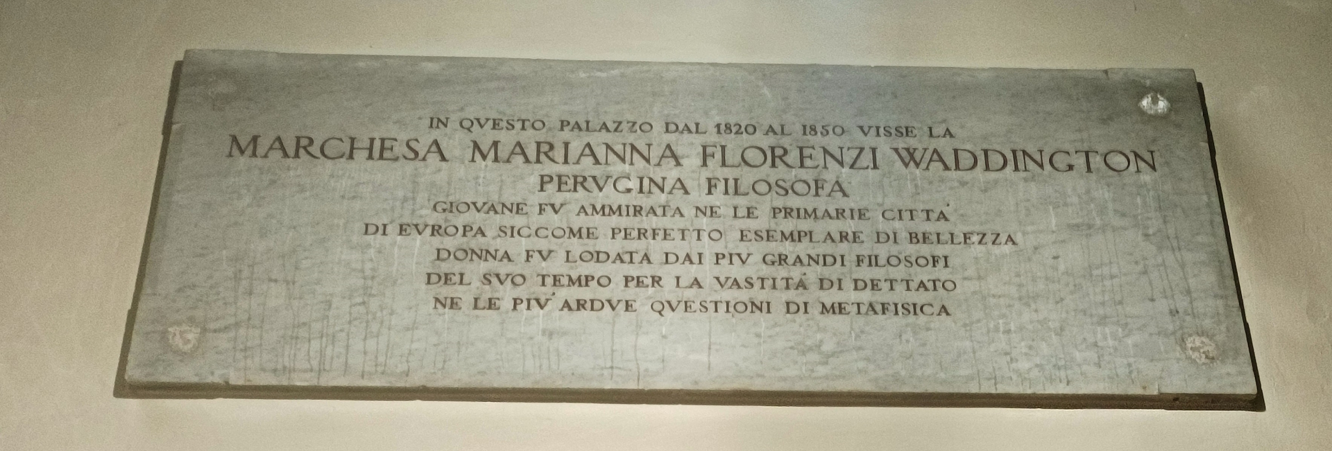 Commemorative plaque at the entrance of Palazzo Florenzi recalling Marianna Florenzi, a philosopher who lived here between 1820 and 1850.