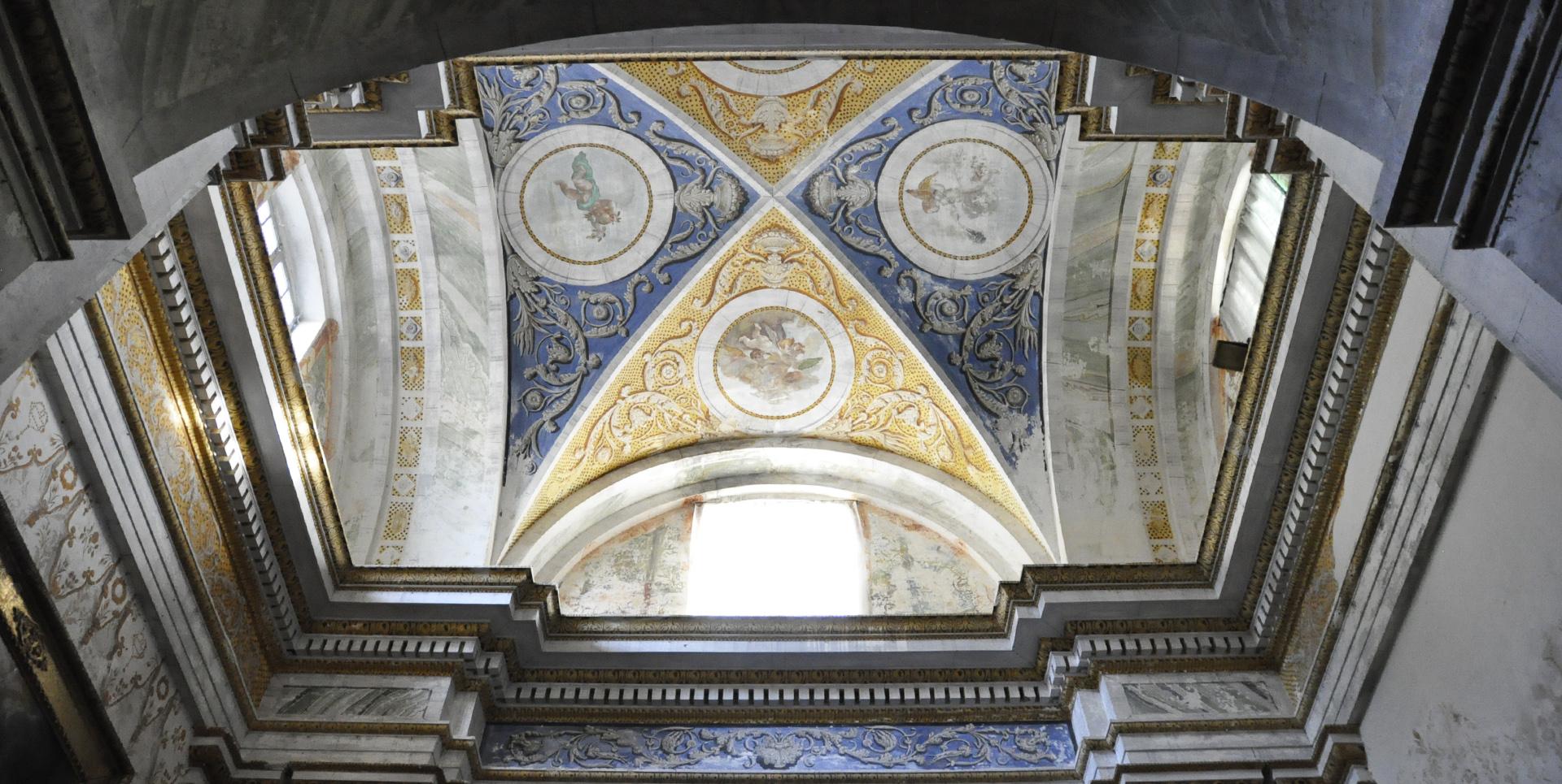 Frescoed vault with golden and blue motifs in the Collegiata di Santa Maria Assunta e San Gregorio in Montone.