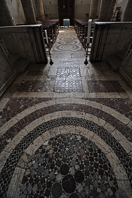 Floor decoration of the Church of Santa Maria Assunta, with geometric motifs in Cosmatesque style in polychrome marble.