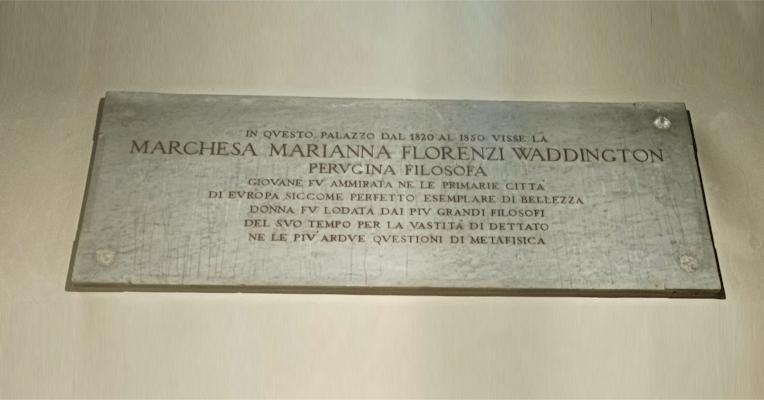 Commemorative plaque at the entrance of Palazzo Florenzi recalling Marianna Florenzi, a philosopher who lived here between 1820 and 1850.