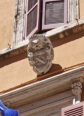Florenzi family coat of arms with a rose branch carved on the sixteenth-century portal of Palazzo Florenzi.