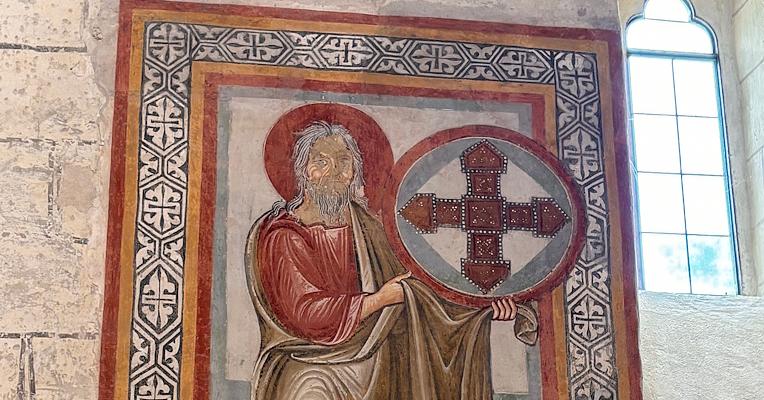 Medieval fresco inside the Church of San Bevignate in Perugia, depicting a sacred figure and Templar cross