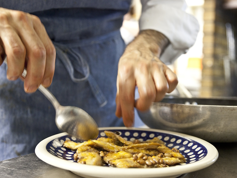 Plate of lake bean salad with perch fillets served on a white and blue plate