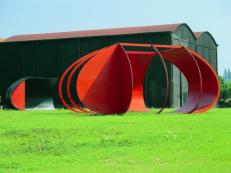 Black and red iron sculptures by Alberto Burri in front of the former Tobacco Drying Sheds in Città di Castello.