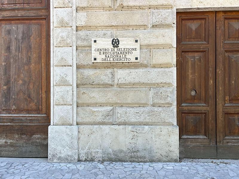 Plaque of the National Army Selection and Recruitment Centre on the stone façade of the Foligno barracks.