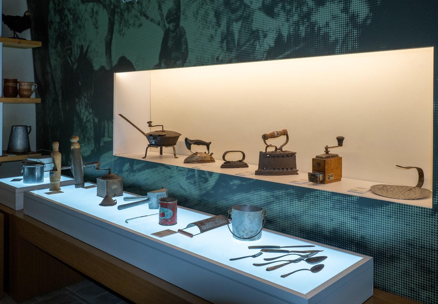 Showcase with flat irons, kitchen utensils and traditional tools exhibited at the MeCC Museum