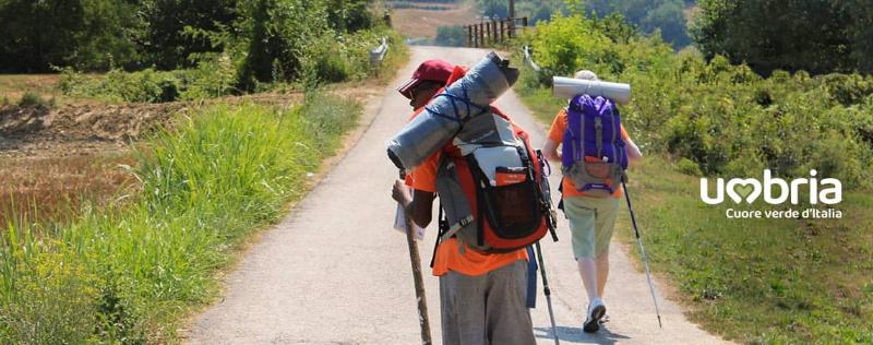 pilgrims walk together on path to san Francesco of Assisi