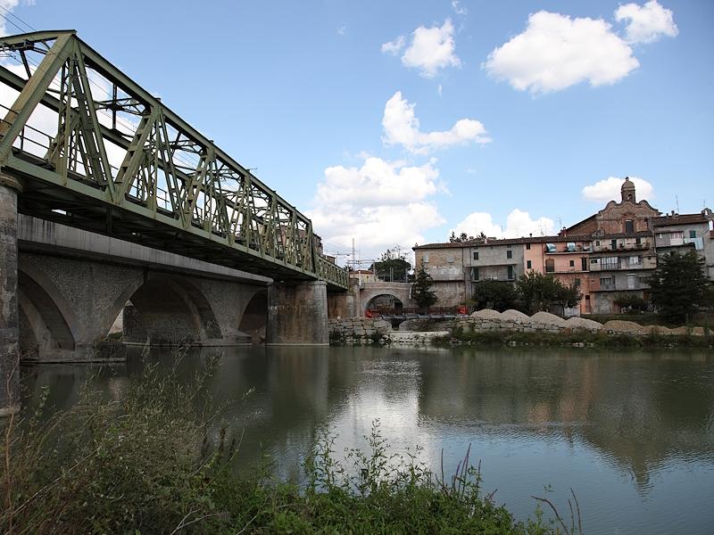 Bridge over the Tiber River with the historic centre of Umbertide in the background.